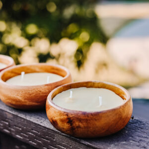 Natural beeswax candles in unique small wooden bowls